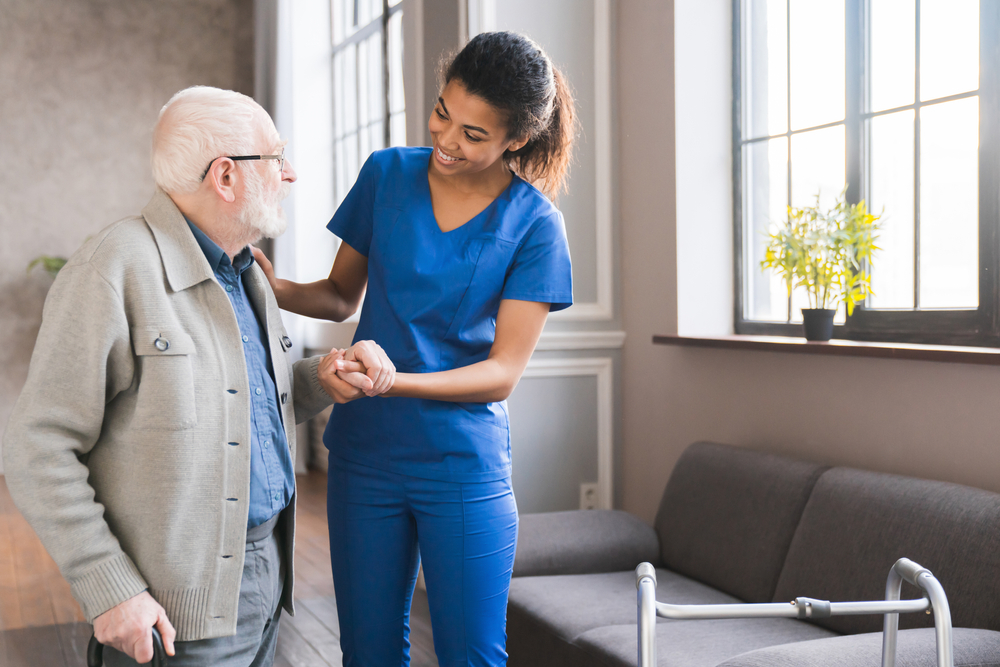 Compassionate caregiver assisting senior at home